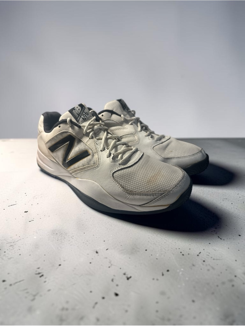 New Balance Men's White and Black Athletic Sneakers with Gold Logo Accent